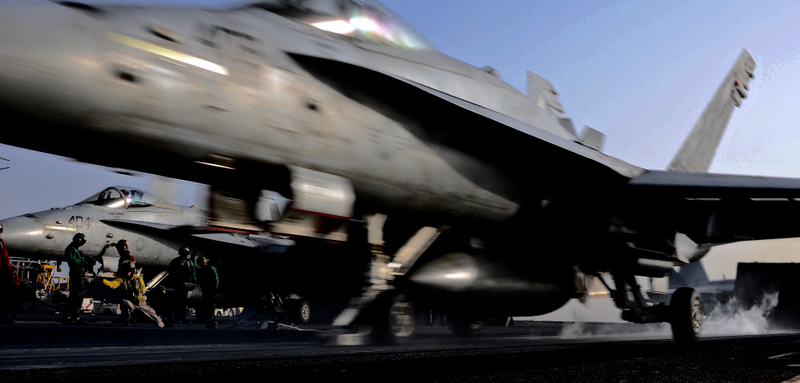 The perfectly in focus Hornet and crew men in the background is special